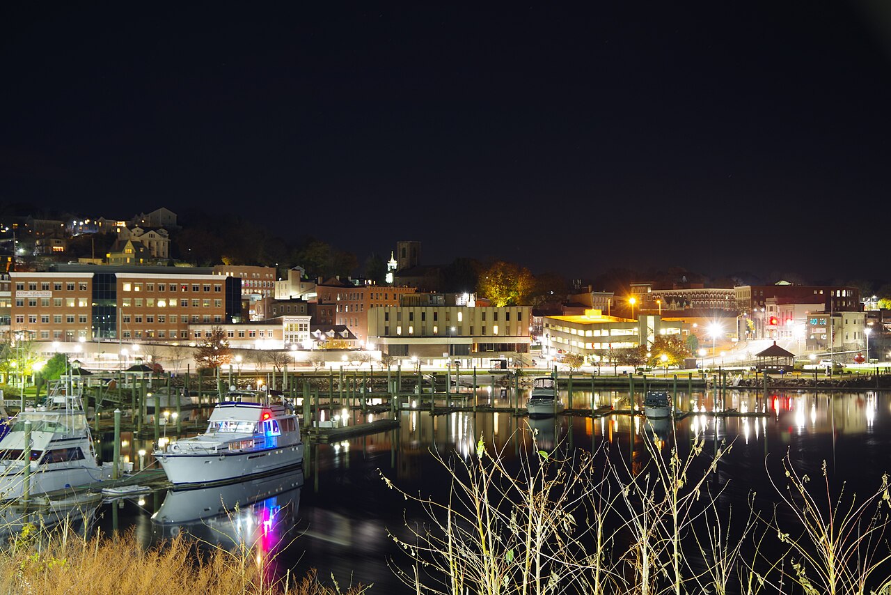 Norwich, Connecticut, illuminated across the harbor at night, photographed in November 2018 by Bobphoenix